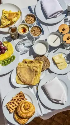 a table with plates of food on it at Le Medina Privilège Riad & Spa in Marrakech