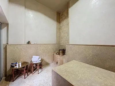 an empty room with two chairs and a table at Le Medina Privilège Riad & Spa in Marrakech