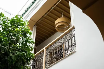 a basket hanging from a balcony at Riad Les Orangers D'alilia in Marrakech
