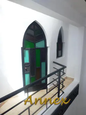a staircase with a stained glass window in a building at Ryad Laârouss Family in Marrakech
