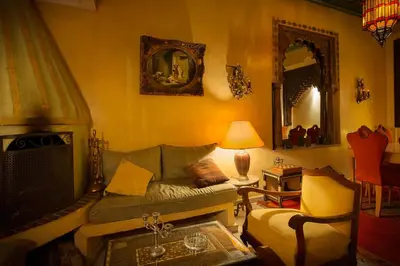 a living room with a couch and a fireplace at Riad Moullaoud in Marrakech