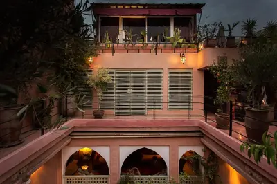 a building with a balcony with plants on it at Riad Moullaoud in Marrakech