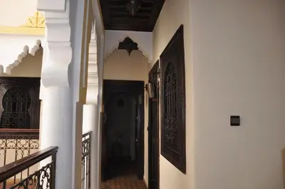 a hallway of a house with white walls and a staircase at Riad des Etoiles in Marrakech