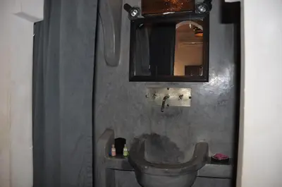 a bathroom with a toilet and a mirror at Riad des Etoiles in Marrakech