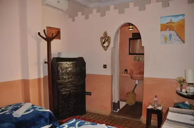 a room with a room with a bed and a bathroom at Riad des Etoiles in Marrakech
