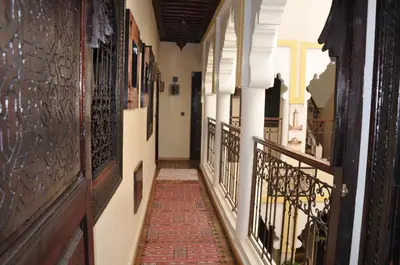 an alleyway in an old building with a balcony at Riad des Etoiles in Marrakech