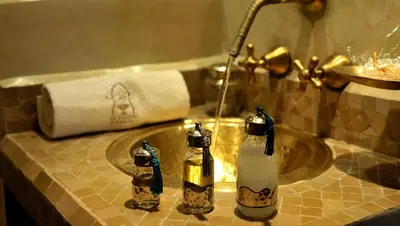 a bathroom sink with two soap bottles on it at Riad Le Jardin d'Abdou in Marrakech