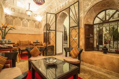 a living room with a table and chairs at Riad Nasreen in Marrakech