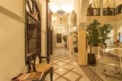 a hallway of a house with a chair and a table at Riad Nasreen in Marrakech