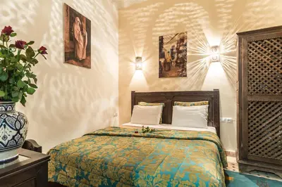 a bedroom with a bed in a room at Riad Nasreen in Marrakech