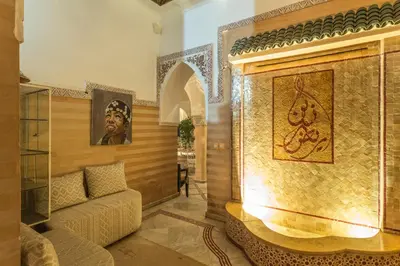 a living room with a couch and a fireplace at Riad Nasreen in Marrakech