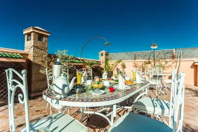 a table and chairs on a patio at Riad Nasreen in Marrakech