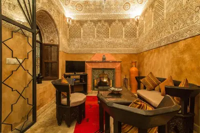 a living room with a couch and a fireplace at Riad Nasreen in Marrakech