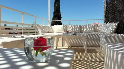 a red rose in a glass vase on a patio at Riad Vendôme & Spa in Marrakech