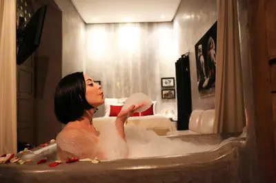 a woman is sitting in a bath tub at Riad Vendôme & Spa in Marrakech
