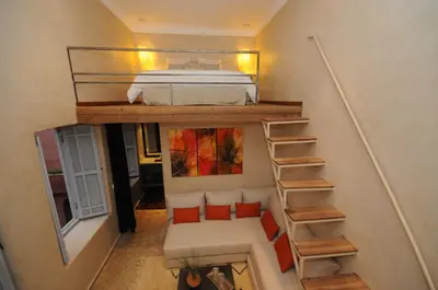 a small room with a bunk bed and a staircase at Riad Vendôme & Spa in Marrakech