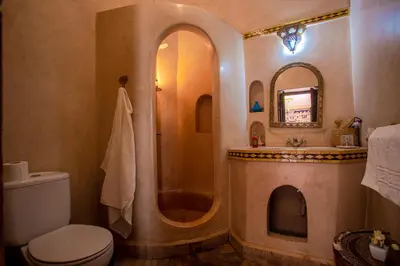 a bathroom with a shower and a toilet and a sink at Riad Le Jardin de Lea, Suites & Spa in Marrakech