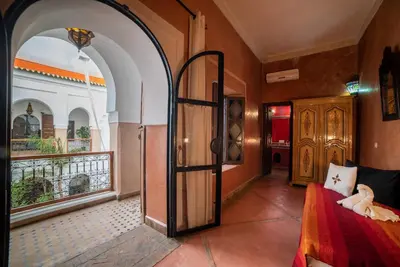 a bedroom with an open door to a balcony at Riad Le Jardin de Lea, Suites & Spa in Marrakech