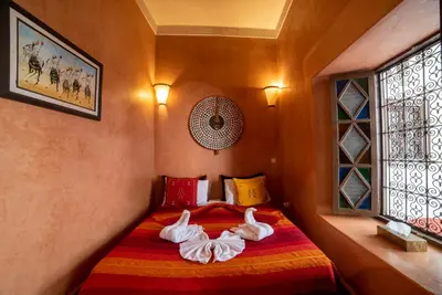 two swans are laying on a bed in a room at Riad Le Jardin de Lea, Suites & Spa in Marrakech