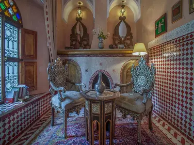 a room with two chairs and a table and a window at Riad & Spa Laurence Olivier in Marrakech