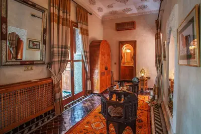 a living room with a couch and a table in it at Riad & Spa Laurence Olivier in Marrakech