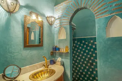 a bathroom with a sink and a shower at Riad & Spa Laurence Olivier in Marrakech