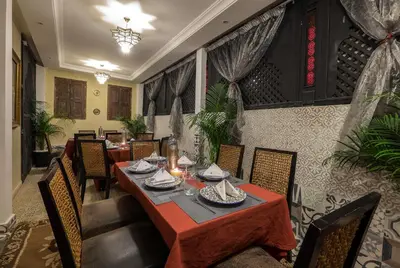 a dining room with a table and chairs at Riad Nesma Suites & Spa in Marrakech