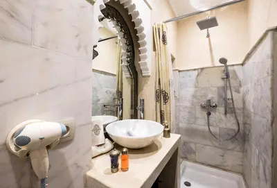 a bathroom with a sink and a shower at Riad Nesma Suites & Spa in Marrakech