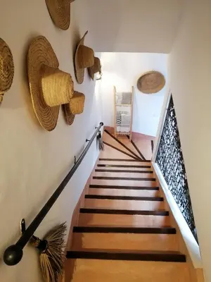 a staircase with wooden floors and baskets on the wall at Riad Dar Nouba in Marrakech