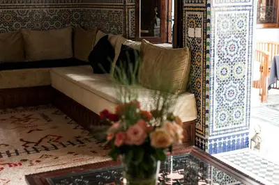 a living room with a couch and a vase with flowers at Dar Sohane in Marrakech