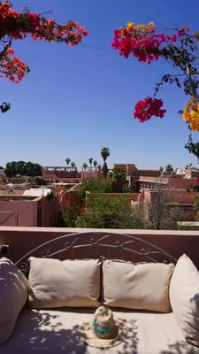 a couch with pillows sitting on top of a balcony at Monriad in Marrakech