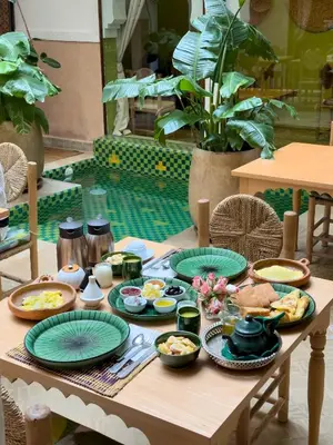 a wooden table with plates of food on it at Monriad in Marrakech