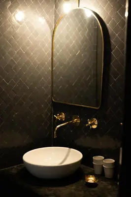 a bathroom with a sink and a mirror at Riad Ajmal in Marrakech