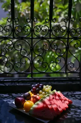 a plate of fruits and vegetables on a table at Riad Ajmal in Marrakech