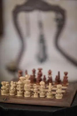 a wooden chess board with chess pieces on it at Riad Dar More in Marrakech