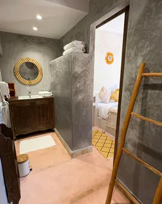 a bathroom with a sink and a mirror at Palais Riad Berbère in Marrakech