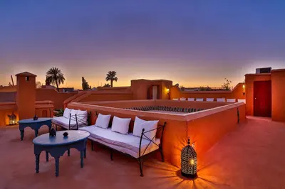 a patio with a couch and a fire place at Hotel & Spa Dar Baraka & Karam in Marrakech