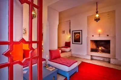a living room with a couch and a fireplace at Hotel & Spa Dar Baraka & Karam in Marrakech