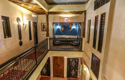 a staircase in a building with a blue train at Riad Christina in Marrakech