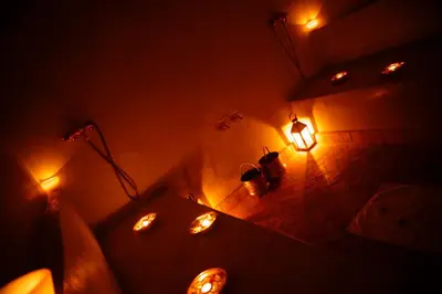 a dark room with lights on the wall and a table at Riad Shama Suites & Spa in Marrakech