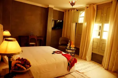 a bedroom with a bed and a bowl of fruit on a table at Riad Shama Suites & Spa in Marrakech