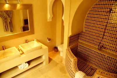 a bathroom with two sinks and a shower and a mirror at Riad Shama Suites & Spa in Marrakech