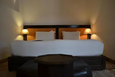 a bedroom with a large white bed with two lamps at Riad Kasbah & Spa in Marrakech