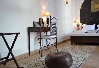 a bedroom with a bed and a desk and a chair at Riad Kasbah & Spa in Marrakech