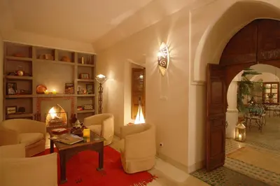 a living room with a table and chairs at Riad Cannelle in Marrakech