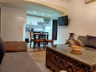 a living room with a couch and a table at Ritaj Apartement in Marrakech
