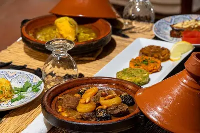 a table with a bowl of food and plates of food at Riad Adika & Spa in Marrakech