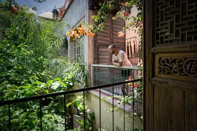 a man standing on a balcony of a house at Riad Kbour & Chou in Marrakech