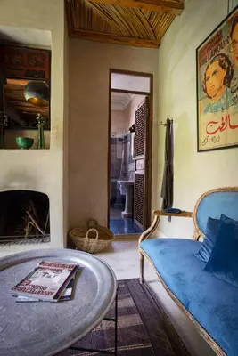 a living room with a bed and a fireplace at Riad Kbour & Chou in Marrakech