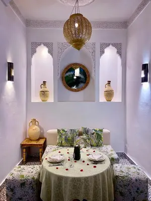 a room with a table with plates and a mirror at Riad Fabiola Et Spa By La Siredrah in Marrakech